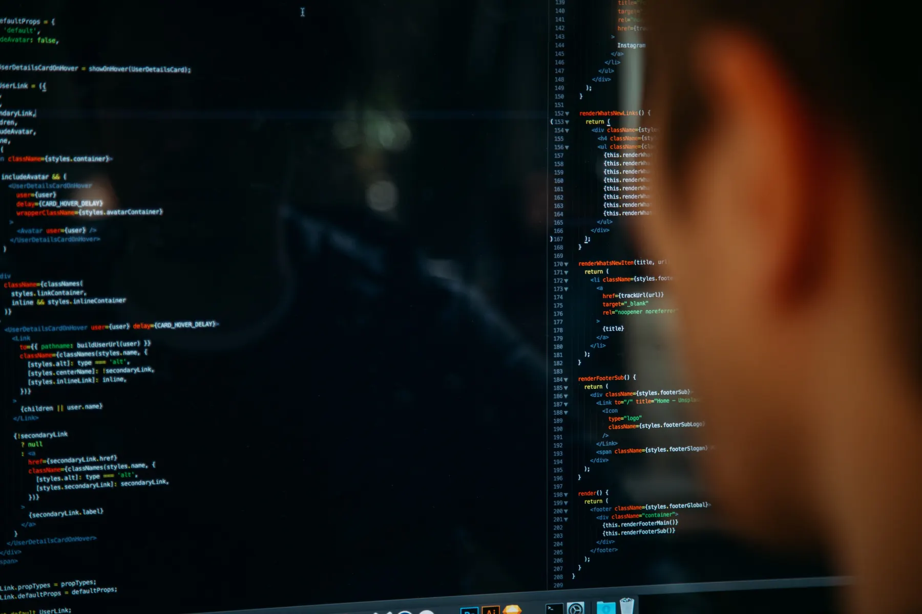 Engineer reviewing source code on a large monitor